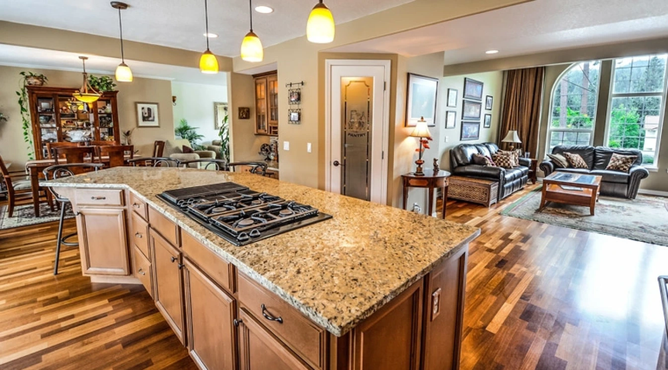 Nice kitchen island with natural stone countertop, matching flooring and cabinets!